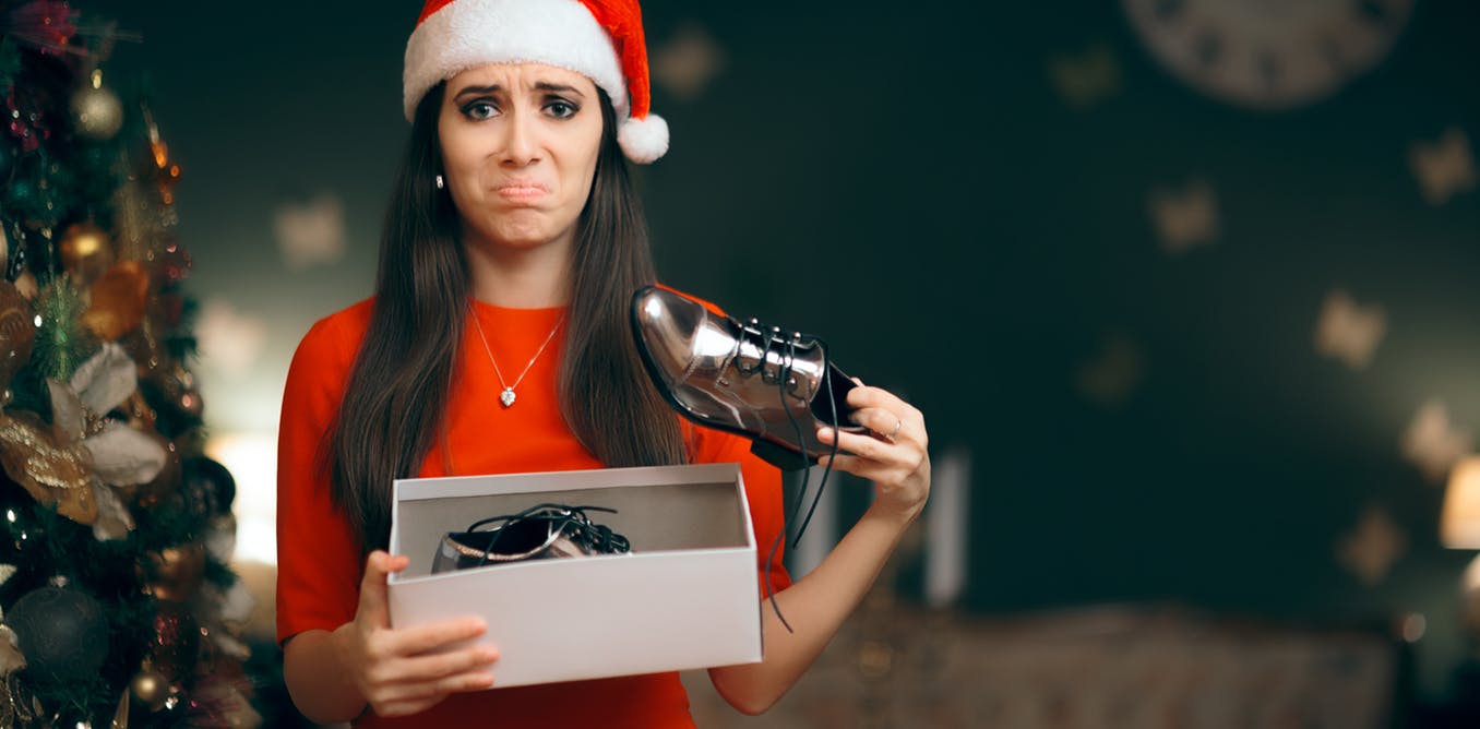 Girl receiving bad Christmas present